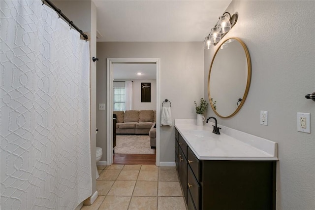 bathroom featuring tile patterned floors, vanity, and toilet