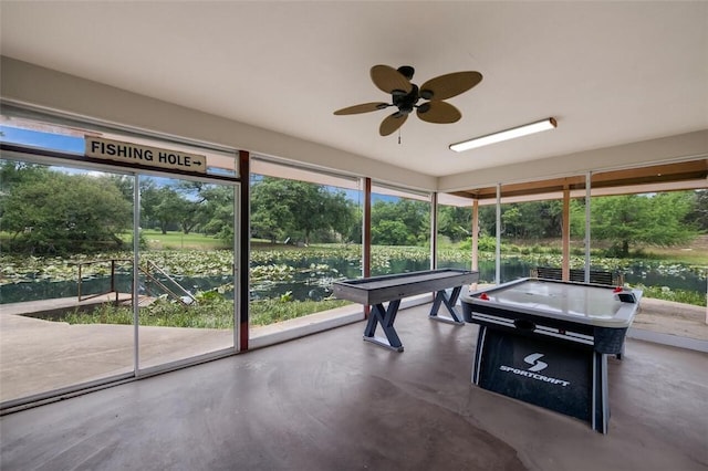 unfurnished sunroom featuring ceiling fan and billiards