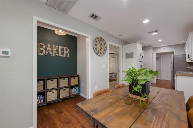 dining area with dark hardwood / wood-style flooring and sink