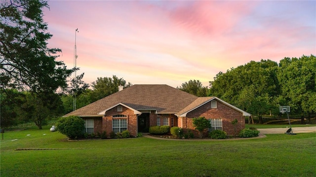 single story home with a lawn