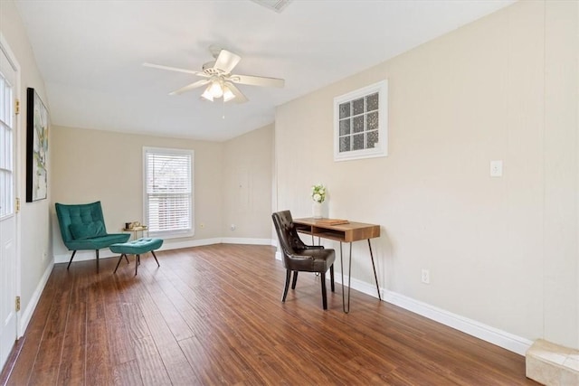 sitting room with a ceiling fan, baseboards, and wood finished floors