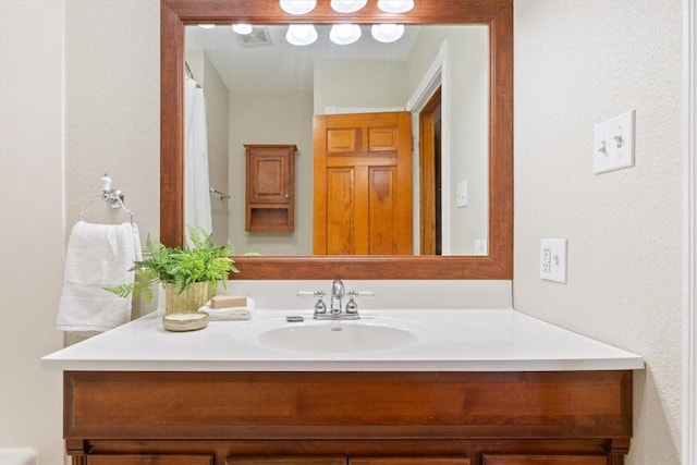 bathroom featuring visible vents and vanity