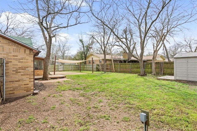 view of yard featuring a fenced backyard, a storage shed, and an outdoor structure