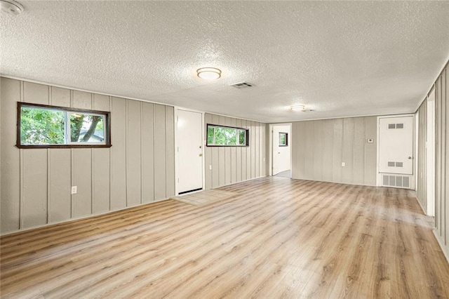 interior space with light hardwood / wood-style flooring and a textured ceiling