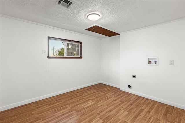 clothes washing area with washer hookup, hookup for an electric dryer, wood-type flooring, and a textured ceiling