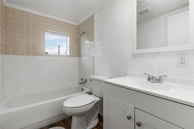 full bathroom featuring ornamental molding, vanity, wood-type flooring, tile walls, and toilet