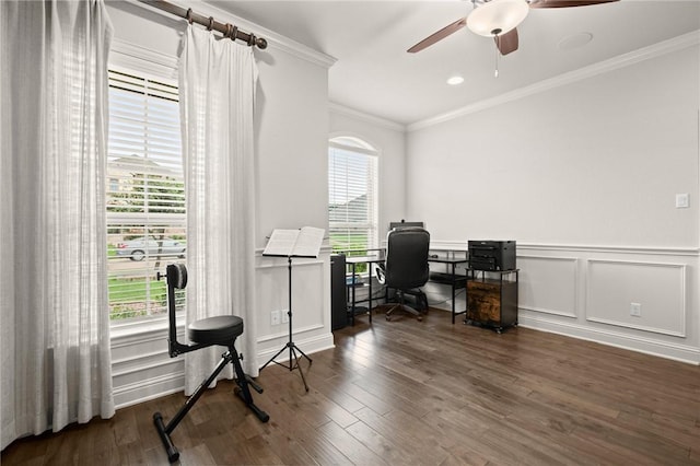 office space with ornamental molding, a ceiling fan, a decorative wall, and wood finished floors