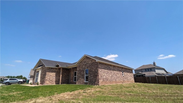 view of side of home featuring a yard