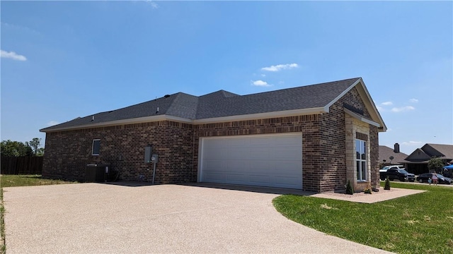 view of home's exterior with a yard, cooling unit, and a garage