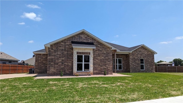 rear view of property with a lawn