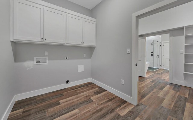 washroom with hookup for an electric dryer, cabinets, dark wood-type flooring, and washer hookup