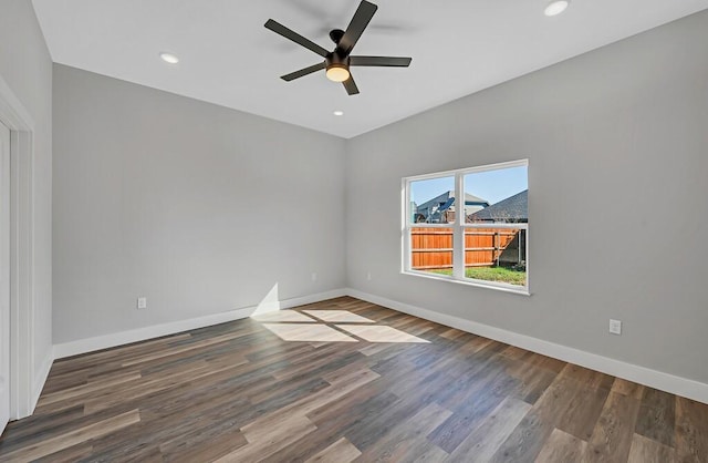 unfurnished room featuring dark hardwood / wood-style floors and ceiling fan