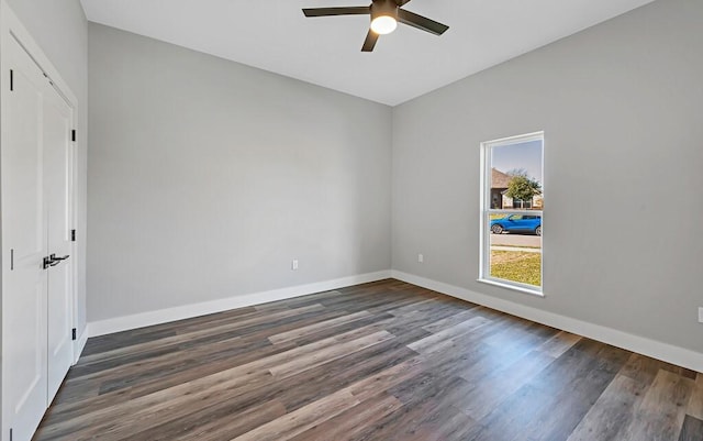 empty room with dark hardwood / wood-style floors and ceiling fan