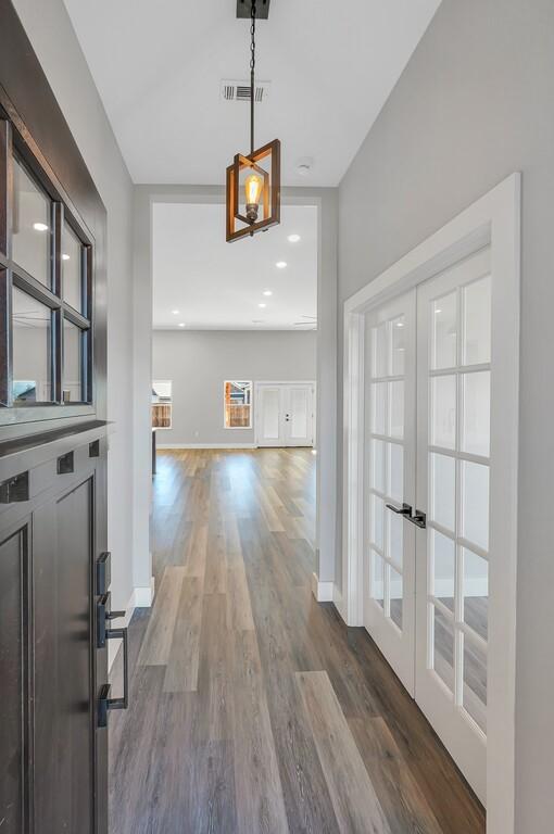 entrance foyer featuring french doors and dark hardwood / wood-style flooring