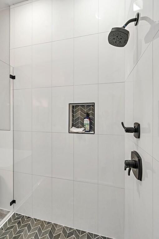 bathroom with a tile shower