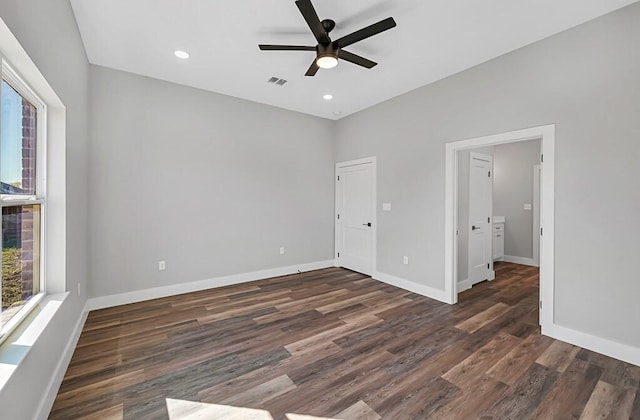 unfurnished bedroom with ceiling fan and dark hardwood / wood-style flooring