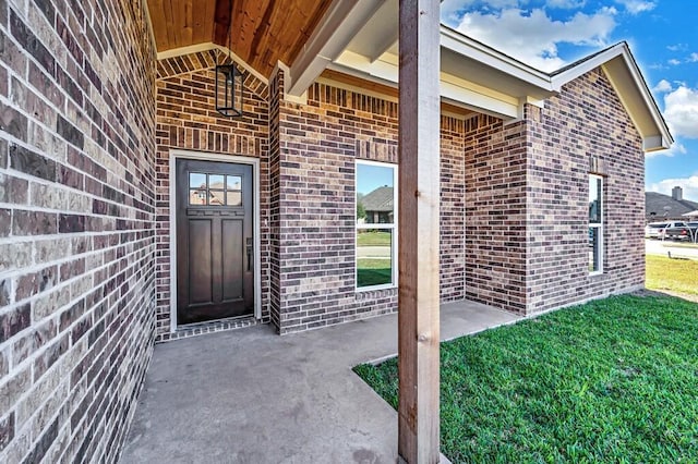 doorway to property with a lawn