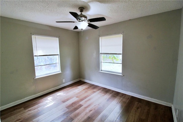 spare room featuring a textured ceiling, light hardwood / wood-style flooring, and a healthy amount of sunlight