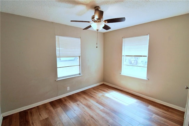 unfurnished room featuring a textured ceiling, light hardwood / wood-style flooring, and ceiling fan