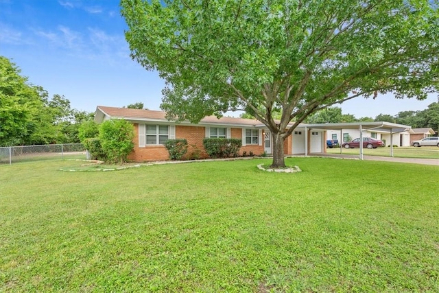 ranch-style house featuring a front lawn and a carport