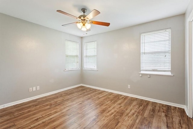 unfurnished room with hardwood / wood-style floors and ceiling fan