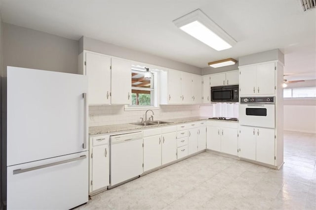 kitchen featuring white cabinets, white appliances, and a healthy amount of sunlight