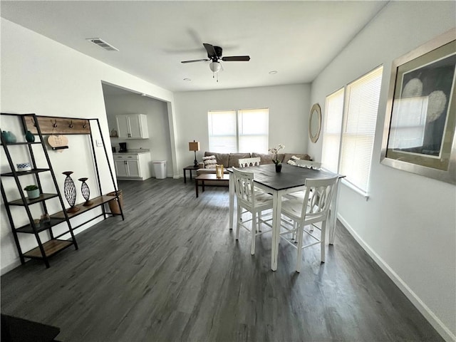 dining space featuring a ceiling fan, dark wood finished floors, visible vents, and baseboards