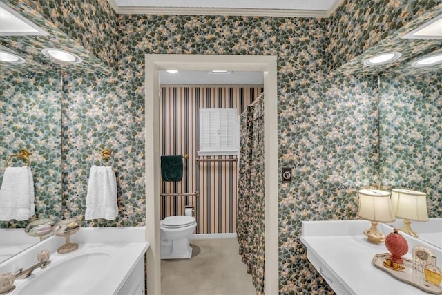 bathroom with vanity, toilet, and crown molding