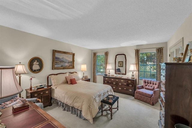 carpeted bedroom featuring a textured ceiling and multiple windows