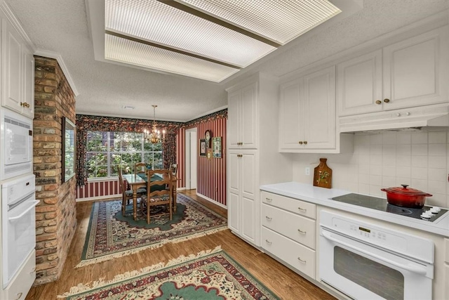 kitchen featuring dark hardwood / wood-style floors, white cabinetry, white appliances, and tasteful backsplash