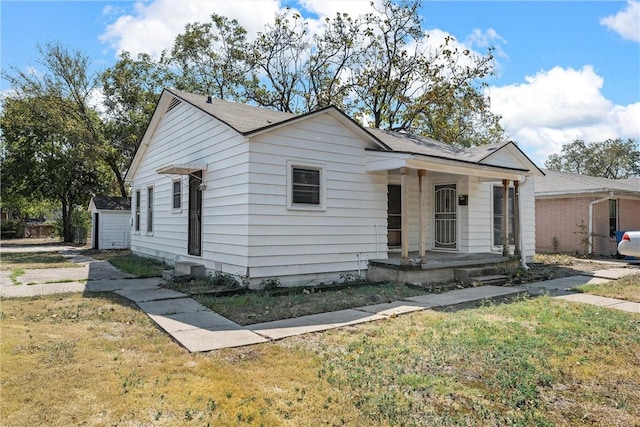 bungalow featuring a porch and a front lawn