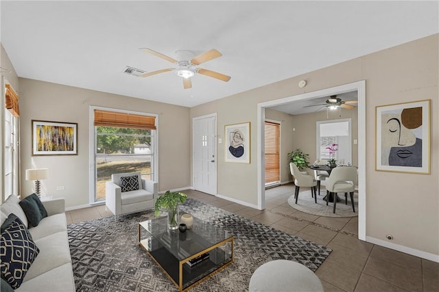 living room featuring tile patterned flooring and ceiling fan