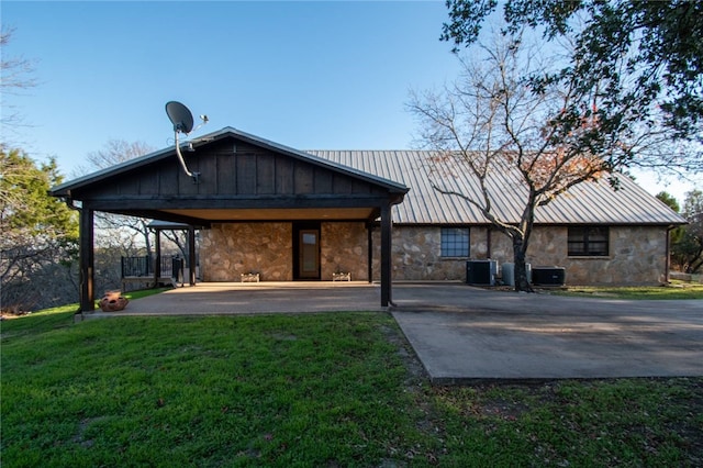 back of house featuring a yard and cooling unit