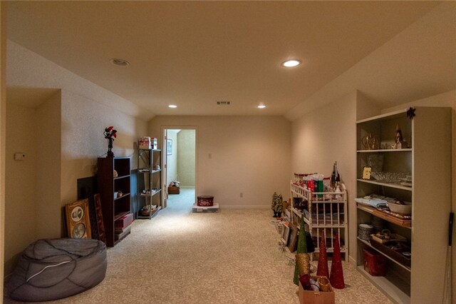 miscellaneous room with lofted ceiling, built in features, and carpet floors