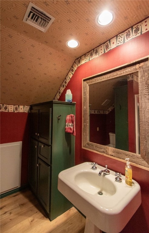 bathroom with sink, wood-type flooring, wooden ceiling, toilet, and lofted ceiling