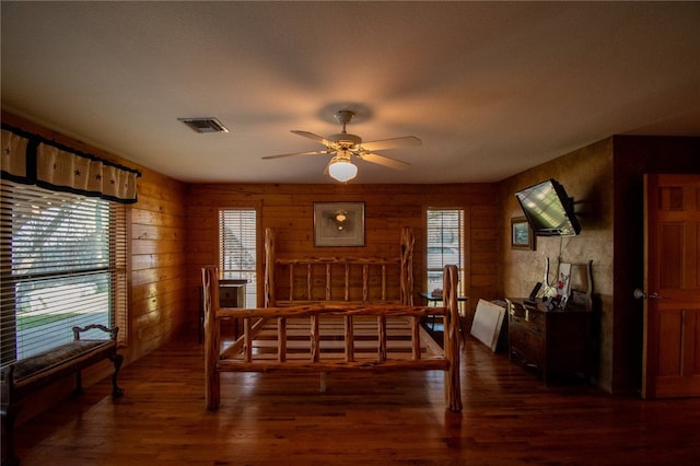 bedroom with multiple windows, ceiling fan, and dark hardwood / wood-style floors