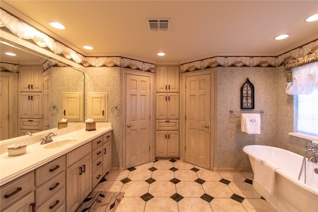 bathroom featuring vanity, a bath, and ornamental molding