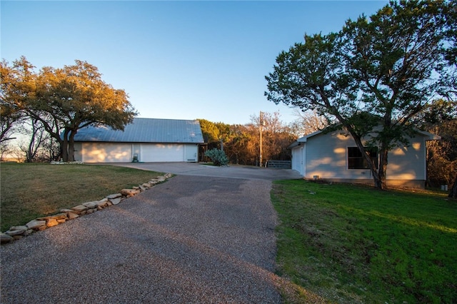 view of side of home with a garage and a yard