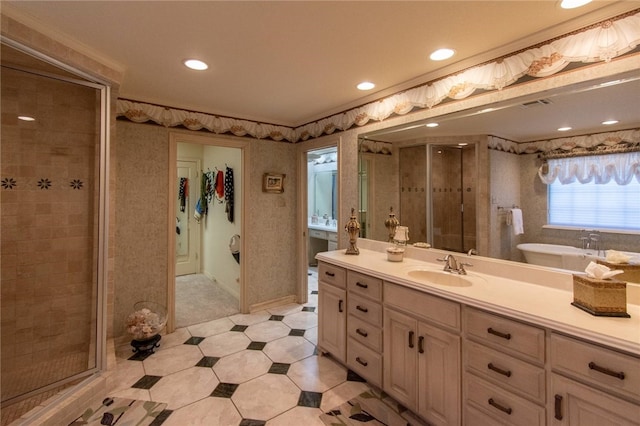 bathroom featuring shower with separate bathtub, vanity, and ornamental molding