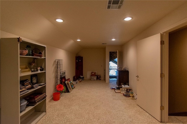 recreation room featuring built in features, carpet floors, and vaulted ceiling