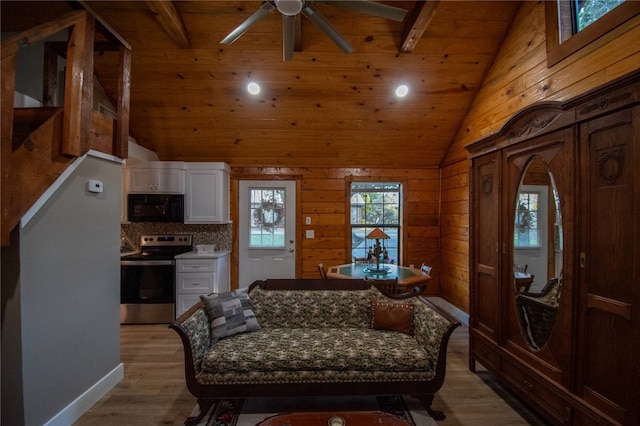 interior space with high vaulted ceiling, light hardwood / wood-style flooring, ceiling fan, beamed ceiling, and wood ceiling