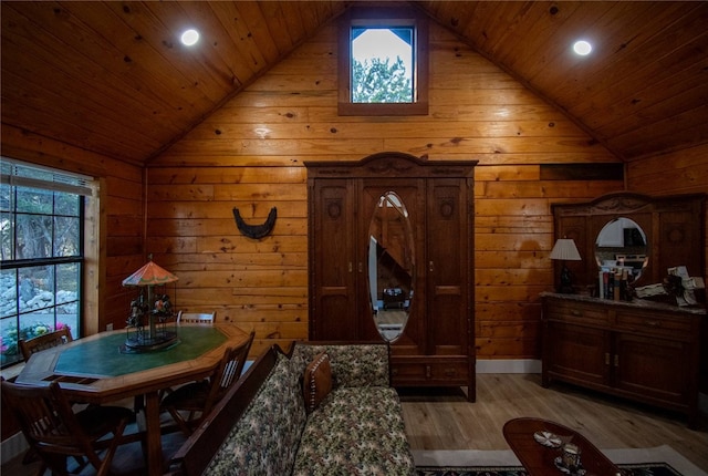 living area with lofted ceiling, light hardwood / wood-style floors, and wooden ceiling