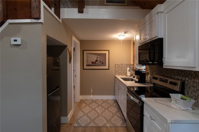 kitchen with white cabinetry, sink, appliances with stainless steel finishes, and tasteful backsplash