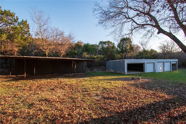 view of yard with a garage and an outdoor structure