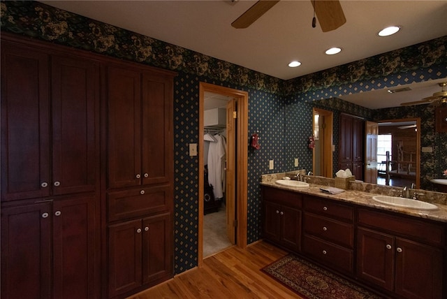 bathroom featuring hardwood / wood-style floors, vanity, and ceiling fan