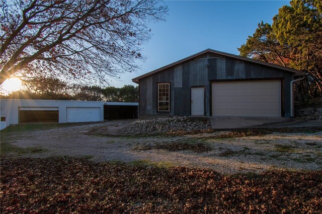 view of garage at dusk