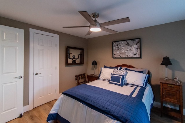 bedroom with light wood-type flooring and ceiling fan