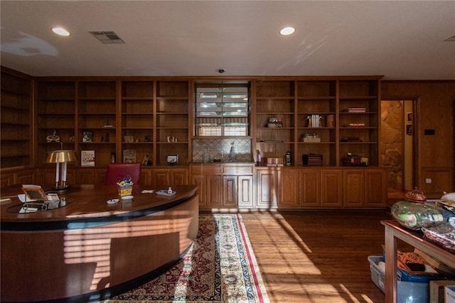 bar featuring dark hardwood / wood-style floors and built in features