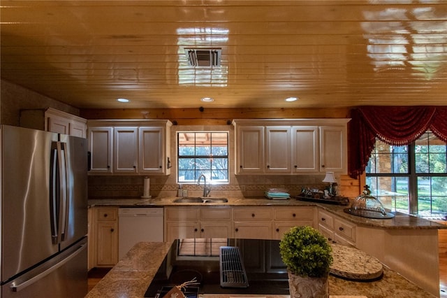 kitchen with dishwasher, stainless steel fridge, plenty of natural light, and sink