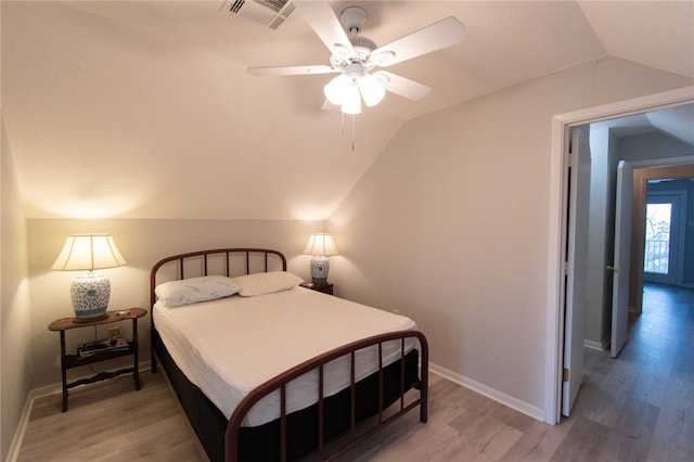 bedroom with ceiling fan, lofted ceiling, and hardwood / wood-style flooring